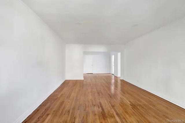 a view of an empty room and wooden floor