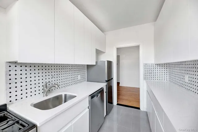 a kitchen with a sink and a refrigerator