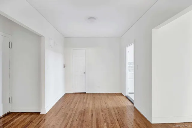 a view of a room with wooden floor