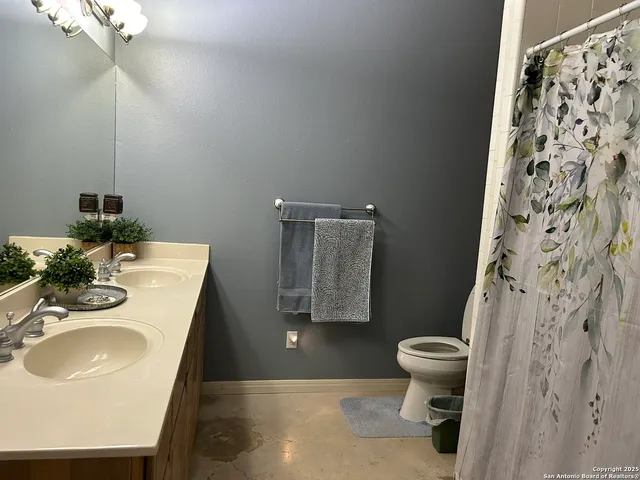 a bathroom with a sink toilet and a mirror
