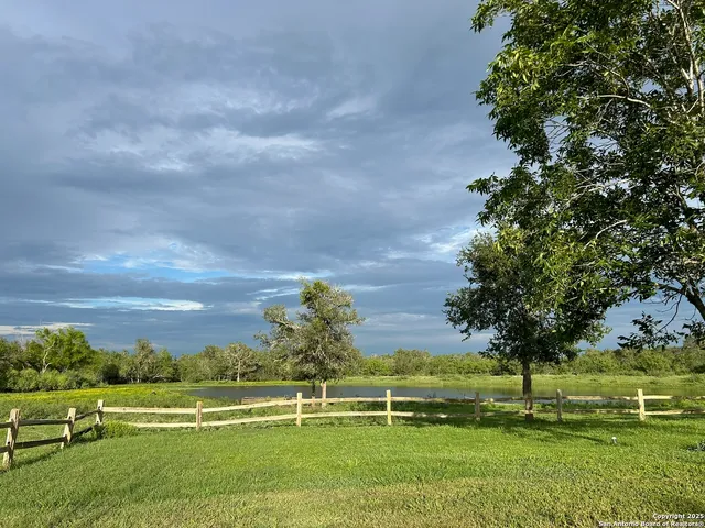 a view of a lake with houses in the back