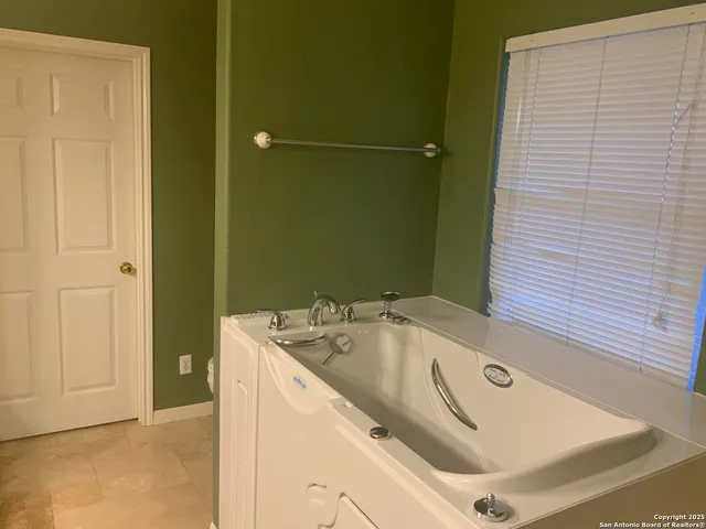 a bathroom with a tub sink and shower