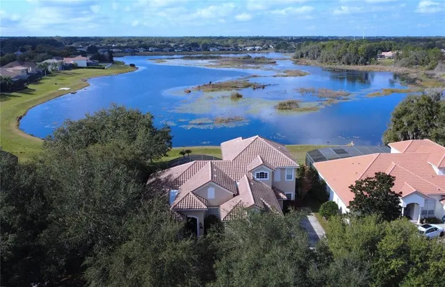 an aerial view of house with yard swimming pool and outdoor seating