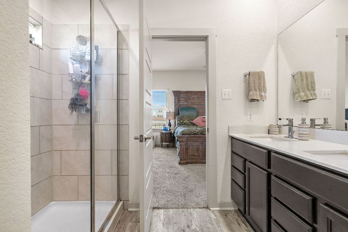 5001 Vanner Path Georgetown, TX 78626 - Photo 15 of 26 a en suite bathroom with a sink a mirror and shower