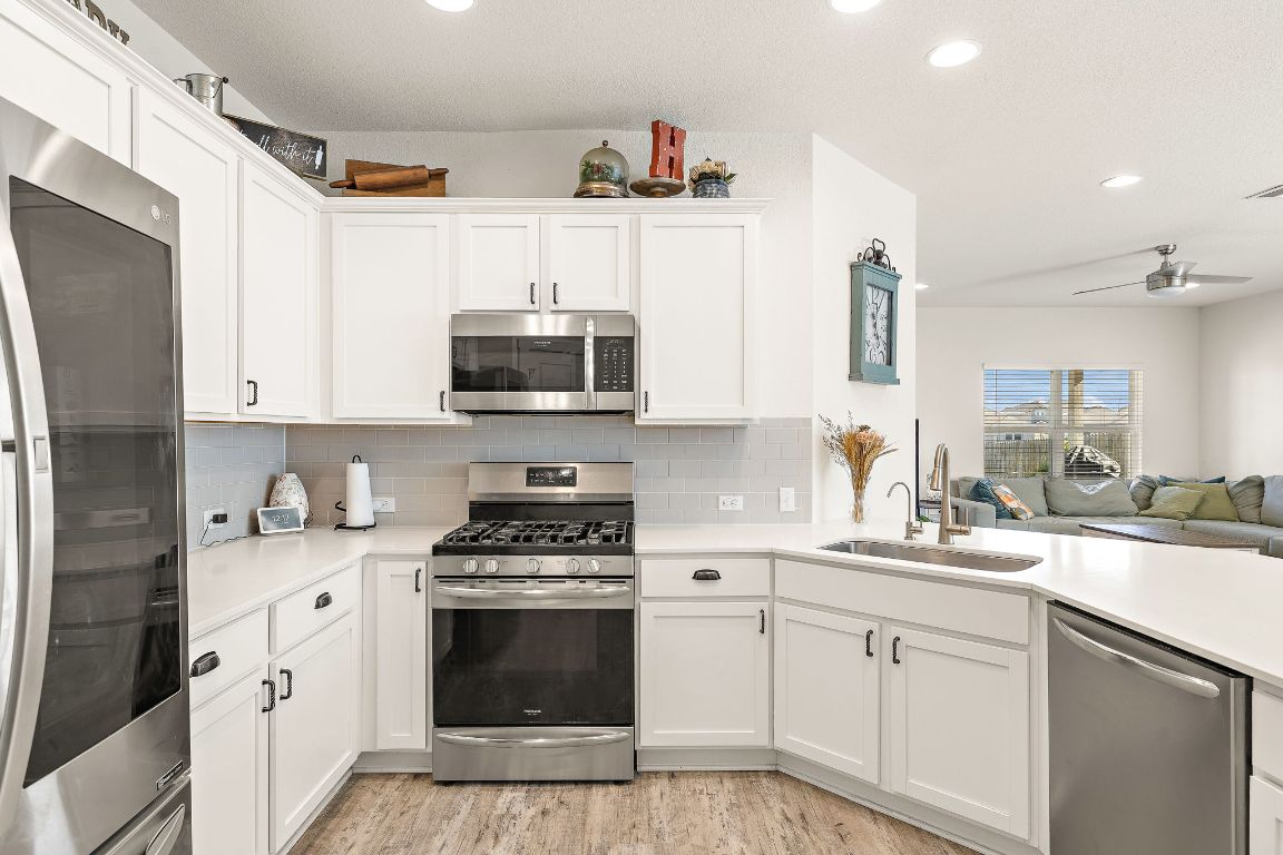 5001 Vanner Path Georgetown, TX 78626 - Photo 26 of 26 a kitchen with white cabinets and appliances