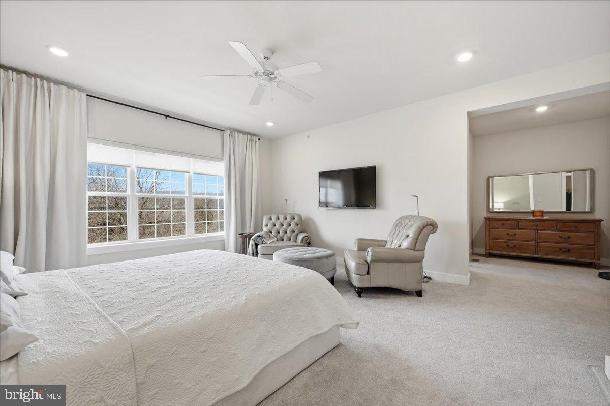 279 Red Leaf Lane Exton, PA 19341 - Photo 17 of 30 a spacious bedroom with a bed a couch and large window