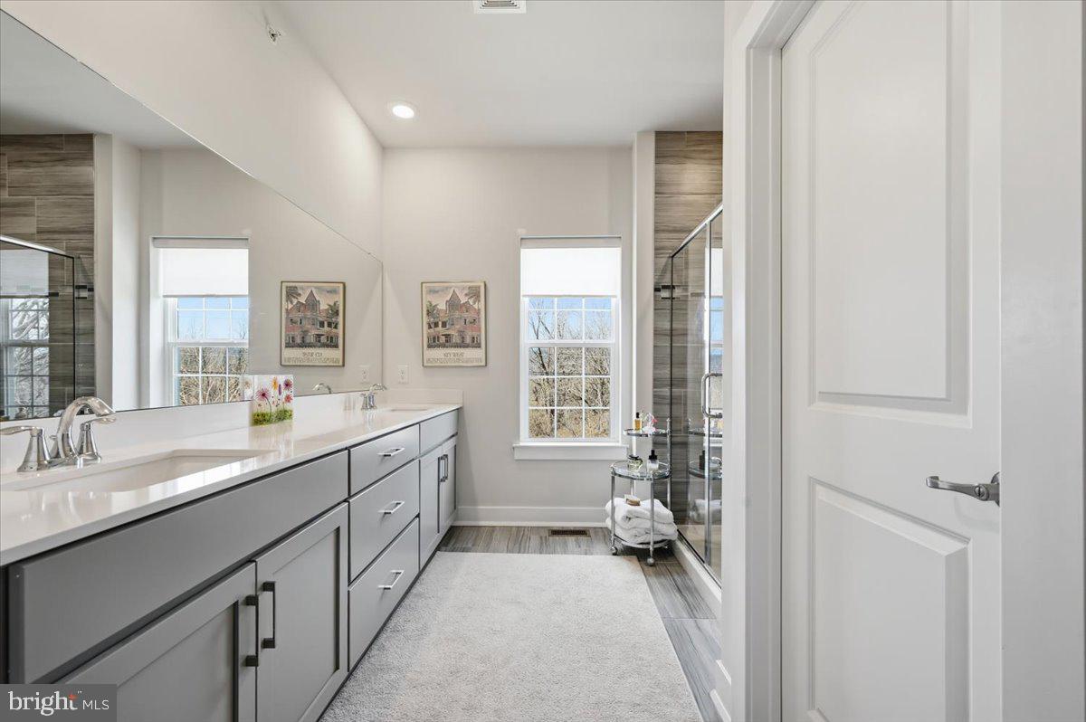 279 Red Leaf Lane Exton, PA 19341 - Photo 18 of 30 a bathroom with a double vanity sink and mirror with shower