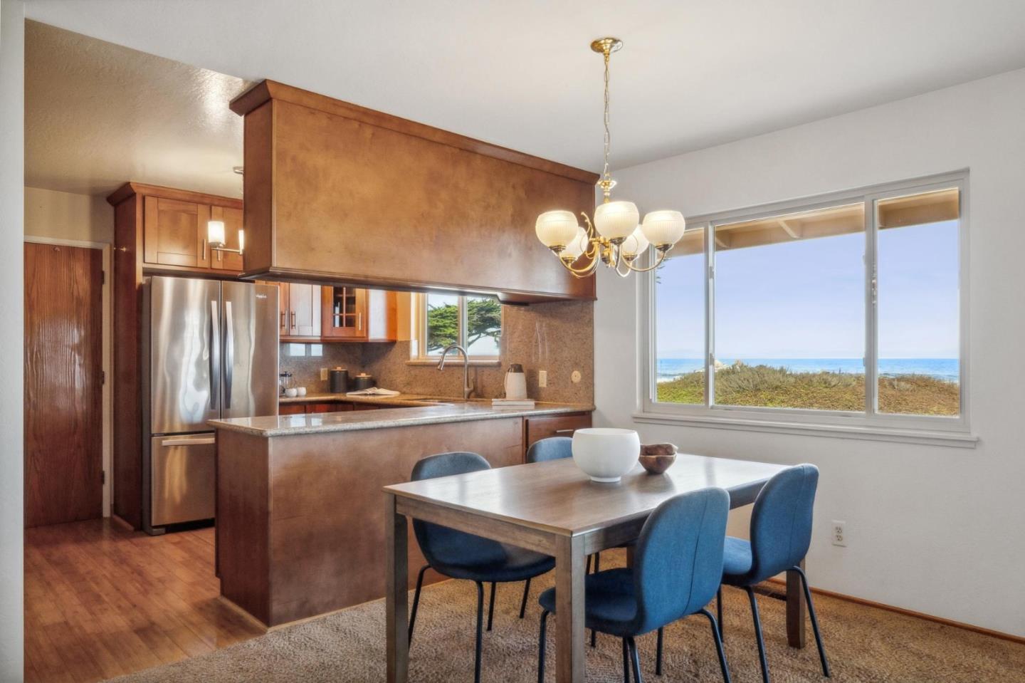1261 Ocean View Boulevard Pacific Grove, CA 93950 - Photo 14 of 37 a view of a dining room with furniture a chandelier and wooden floor