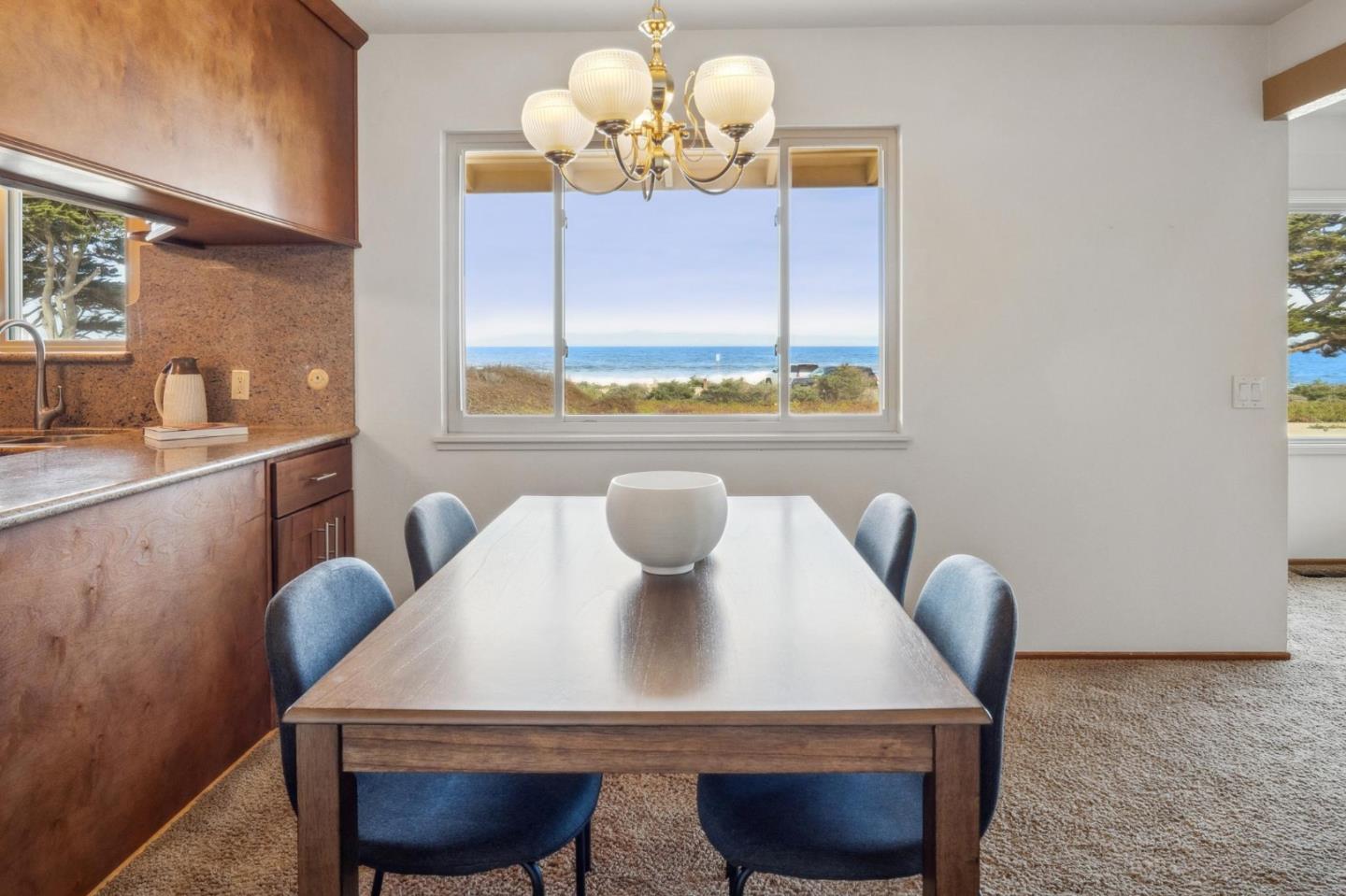 1261 Ocean View Boulevard Pacific Grove, CA 93950 - Photo 15 of 37 a view of a dining room with furniture and chandelier