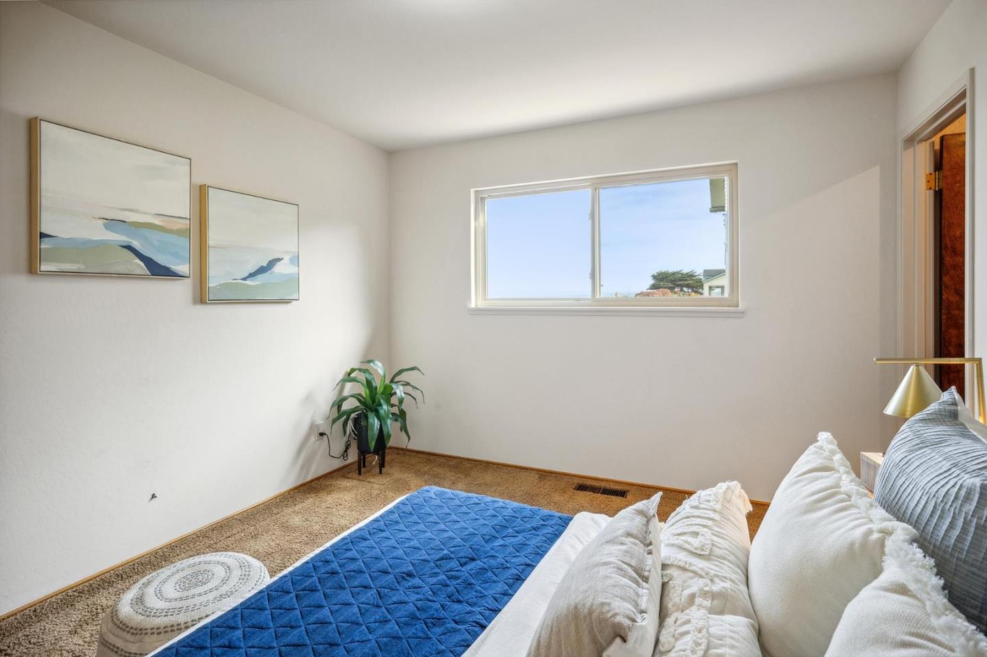 1261 Ocean View Boulevard Pacific Grove, CA 93950 - Photo 19 of 37 a bedroom with bed and a window