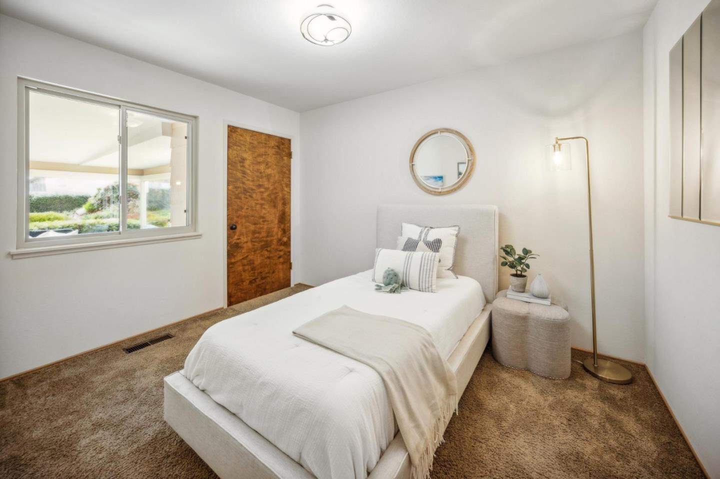 1261 Ocean View Boulevard Pacific Grove, CA 93950 - Photo 23 of 37 a bedroom with a bed and a window