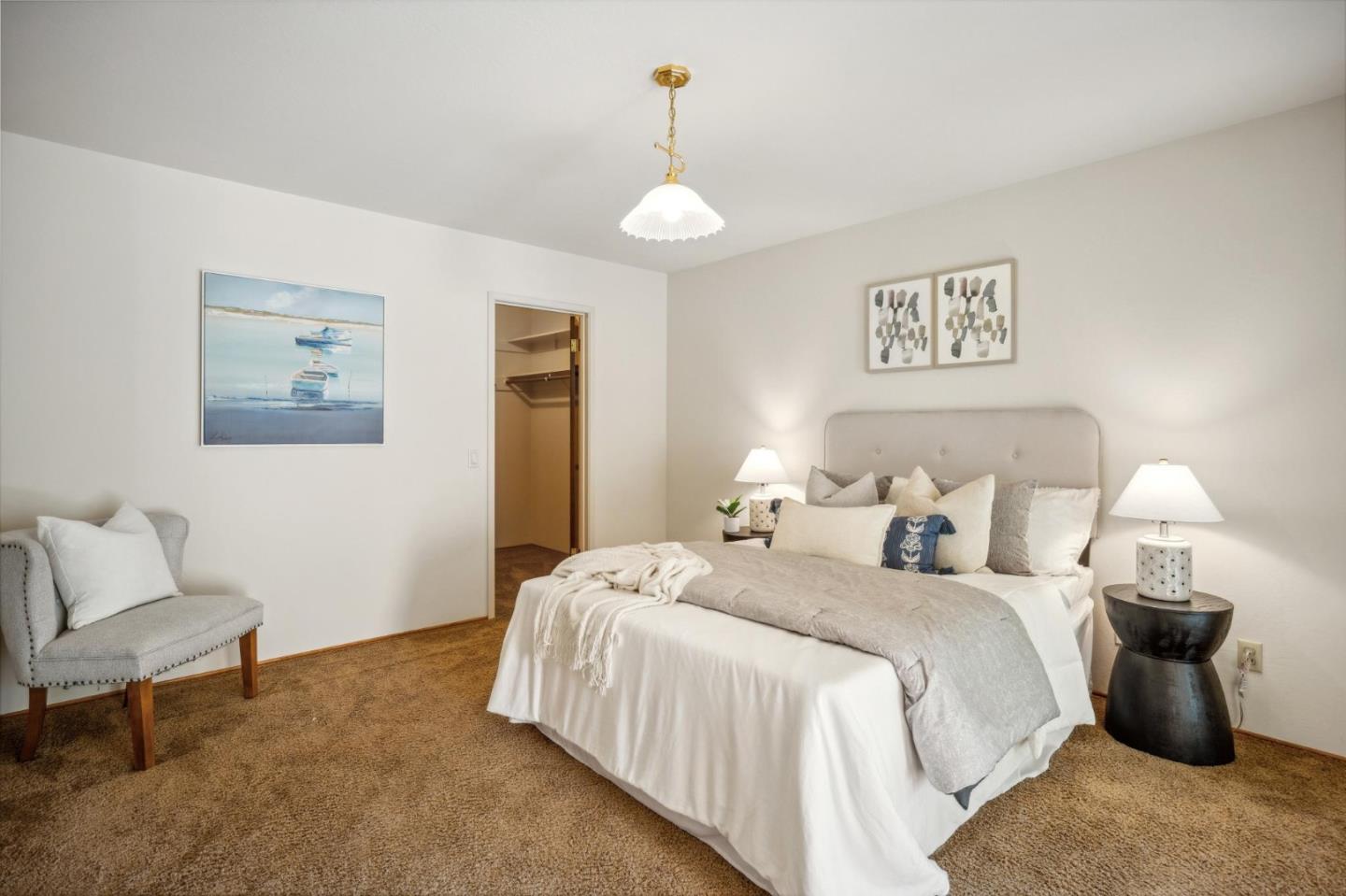 1261 Ocean View Boulevard Pacific Grove, CA 93950 - Photo 24 of 37 a bedroom with a bed and a chair