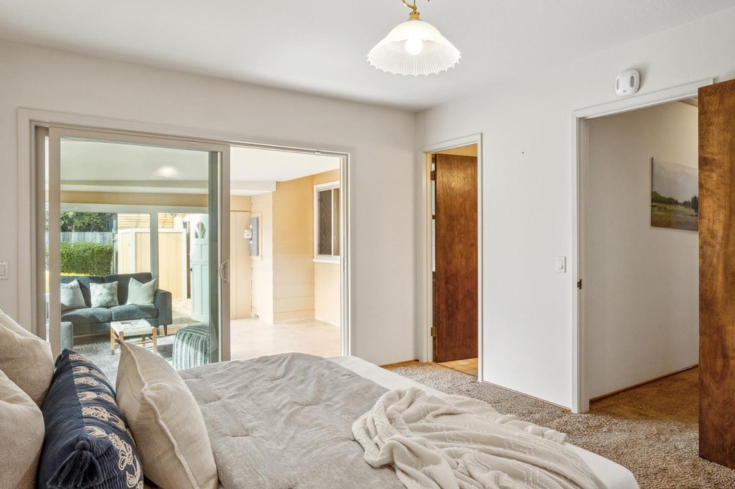 1261 Ocean View Boulevard Pacific Grove, CA 93950 - Photo 26 of 37 a bedroom with a bed and a large window