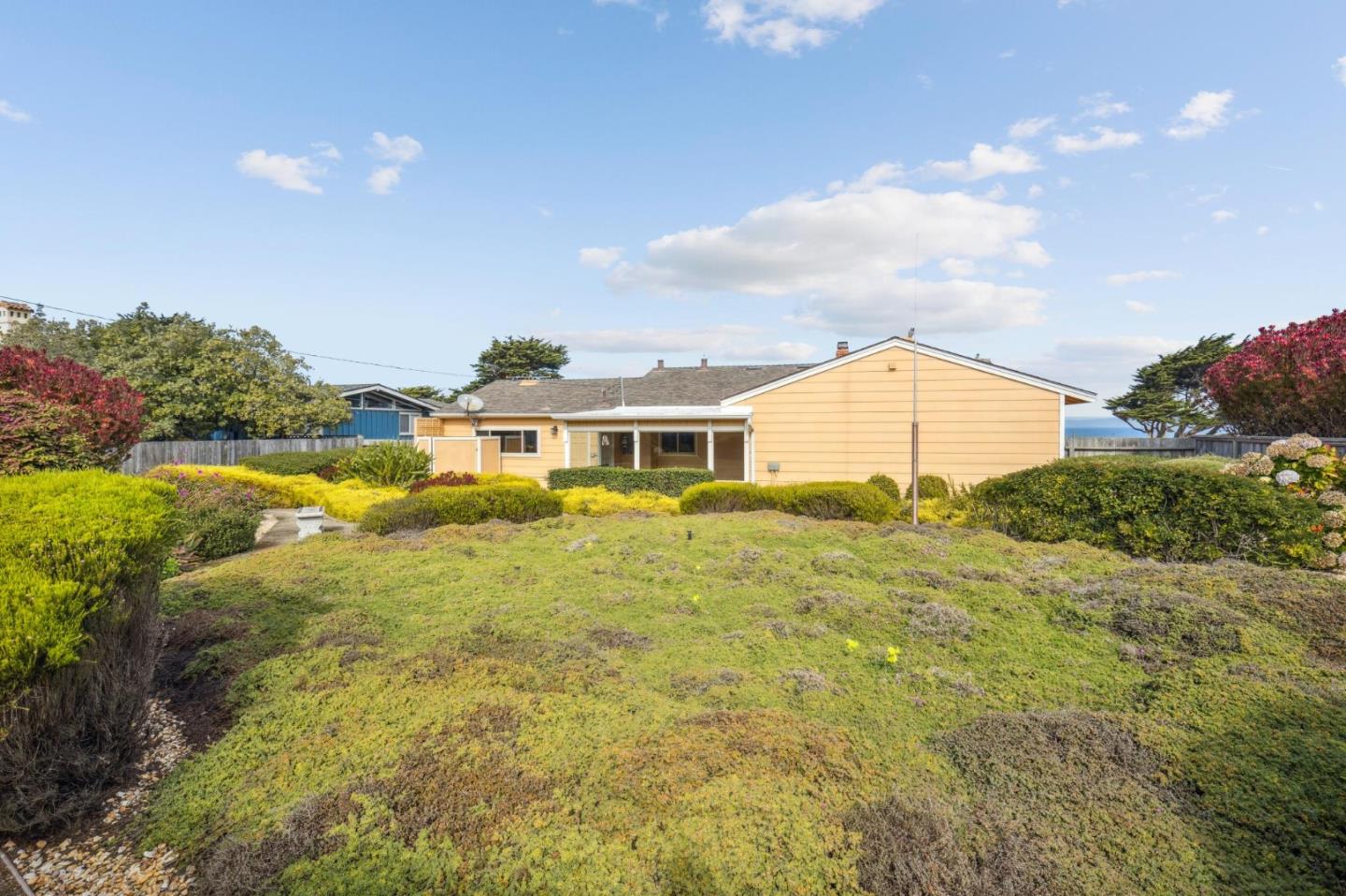 1261 Ocean View Boulevard Pacific Grove, CA 93950 - Photo 30 of 37 a front view of a house with a garden