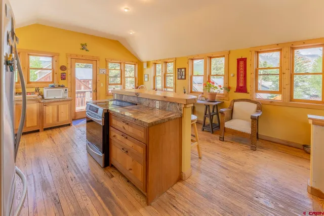 a living room with furniture fireplace and a large window