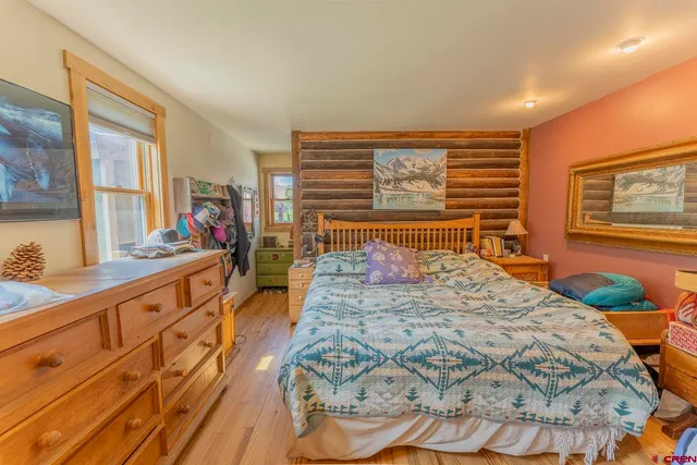 a bed sitting in a bedroom next to a window