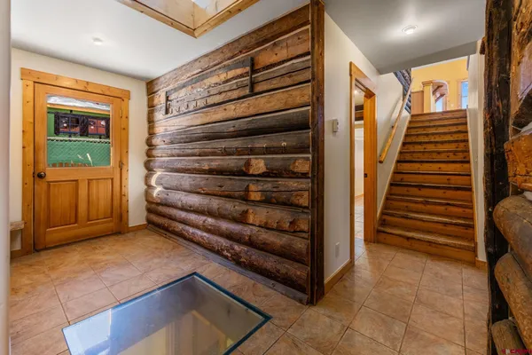 a view of a hallway with stairs and a window