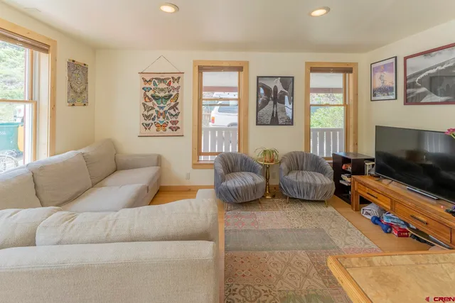 a view of a livingroom with furniture and a window