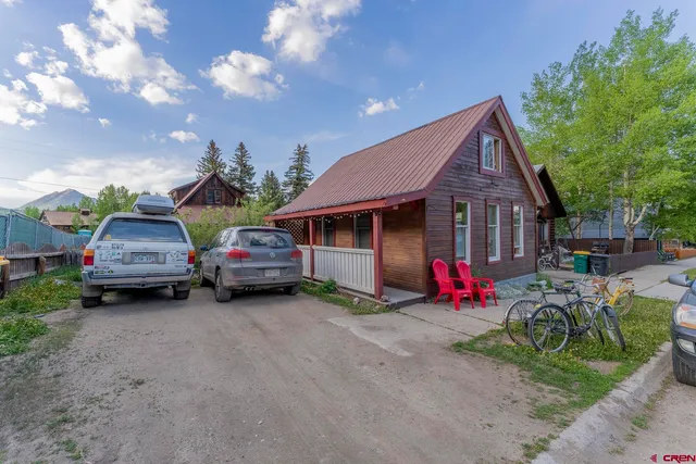 a view of a house with a patio and a yard