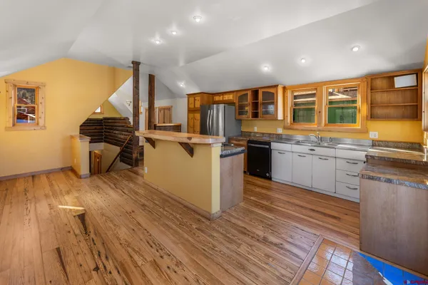 a kitchen with stainless steel appliances granite countertop a stove and wooden floor
