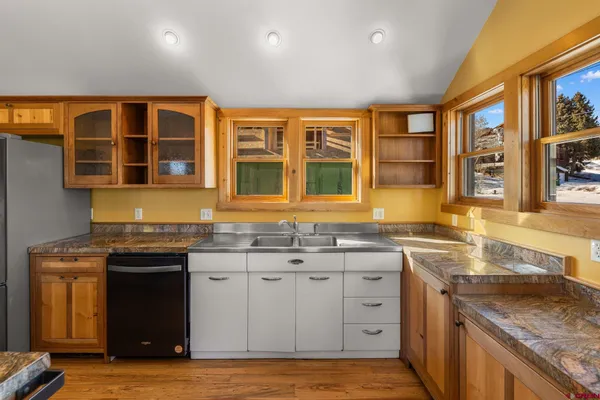a kitchen with stainless steel appliances granite countertop a stove and a sink