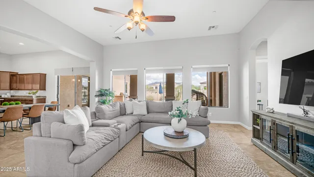 a bed sitting in a spacious bedroom next to a window