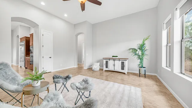 a spacious bathroom with a granite countertop sink a large mirror a bathtub and a window