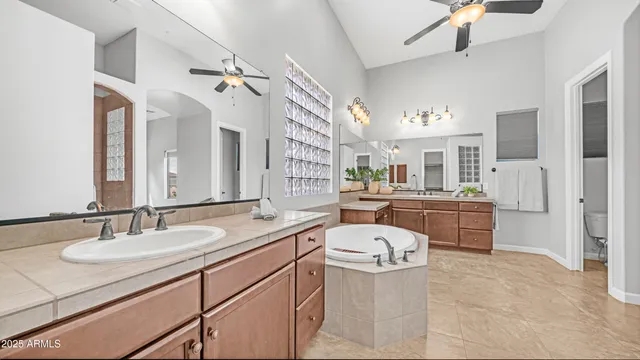 a spacious bathroom with a double vanity sink mirror and toilet