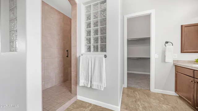 a bathroom with a granite countertop sink a toilet and a mirror