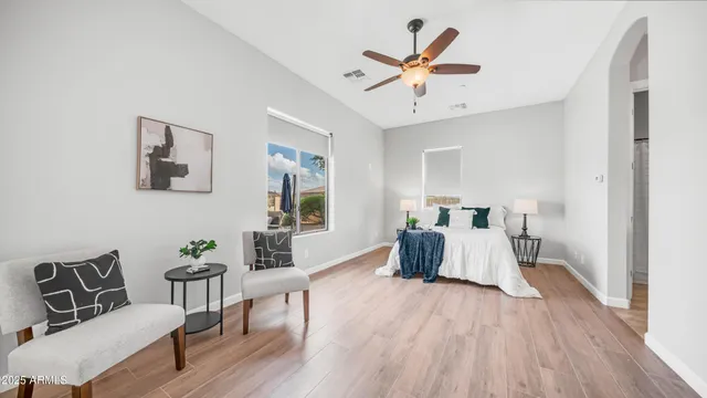 a view of a swimming pool with a chairs and tables in patio