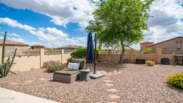 a living room with furniture kitchen view and a large window