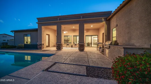 a view of swimming pool with a lounge chairs
