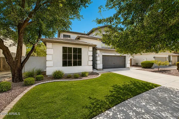 a front view of a house with a yard and garage