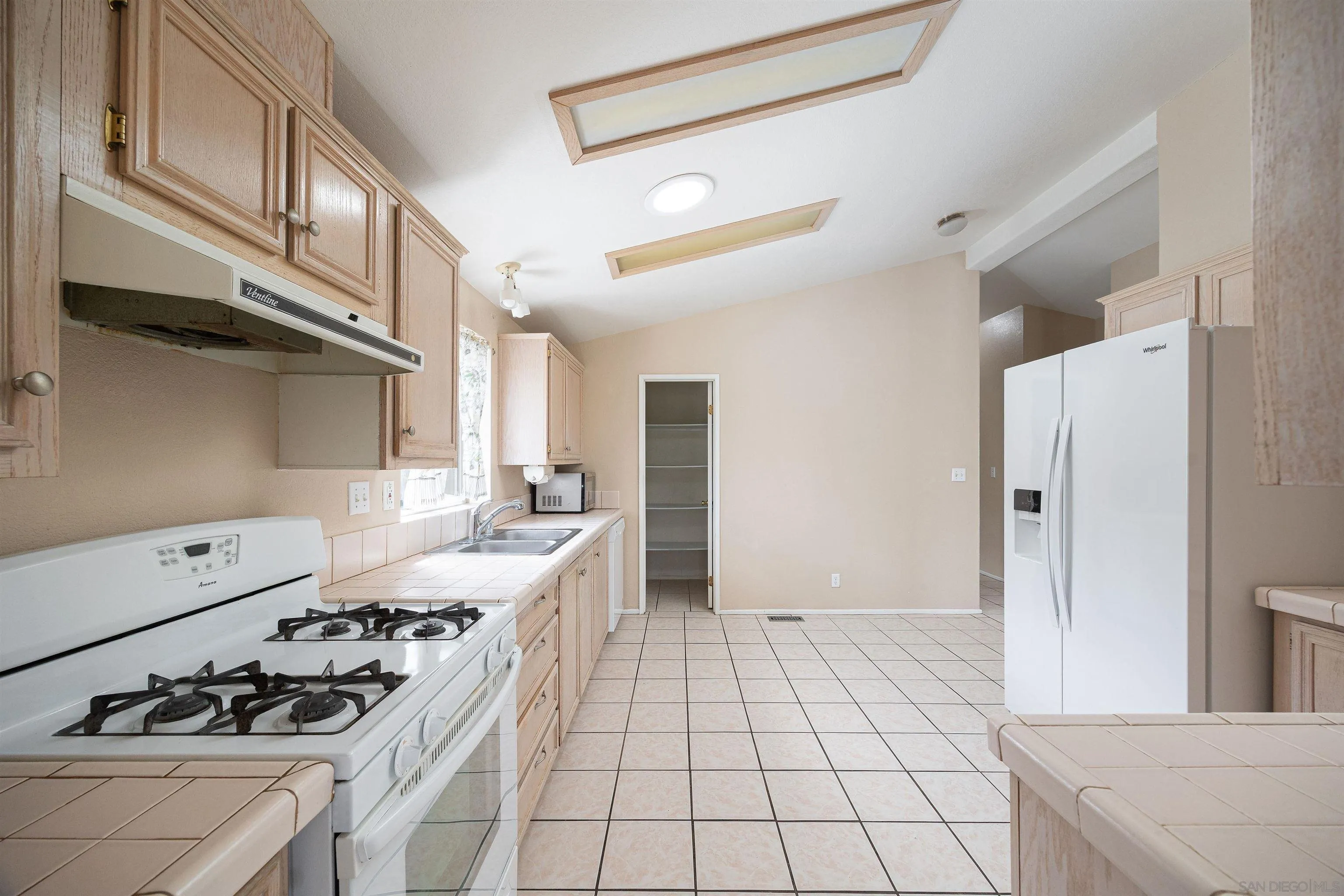 4650 Dulin Road, Unit 162 Fallbrook, CA 92003 - Photo 11 of 36 a kitchen with a stove a sink and a refrigerator