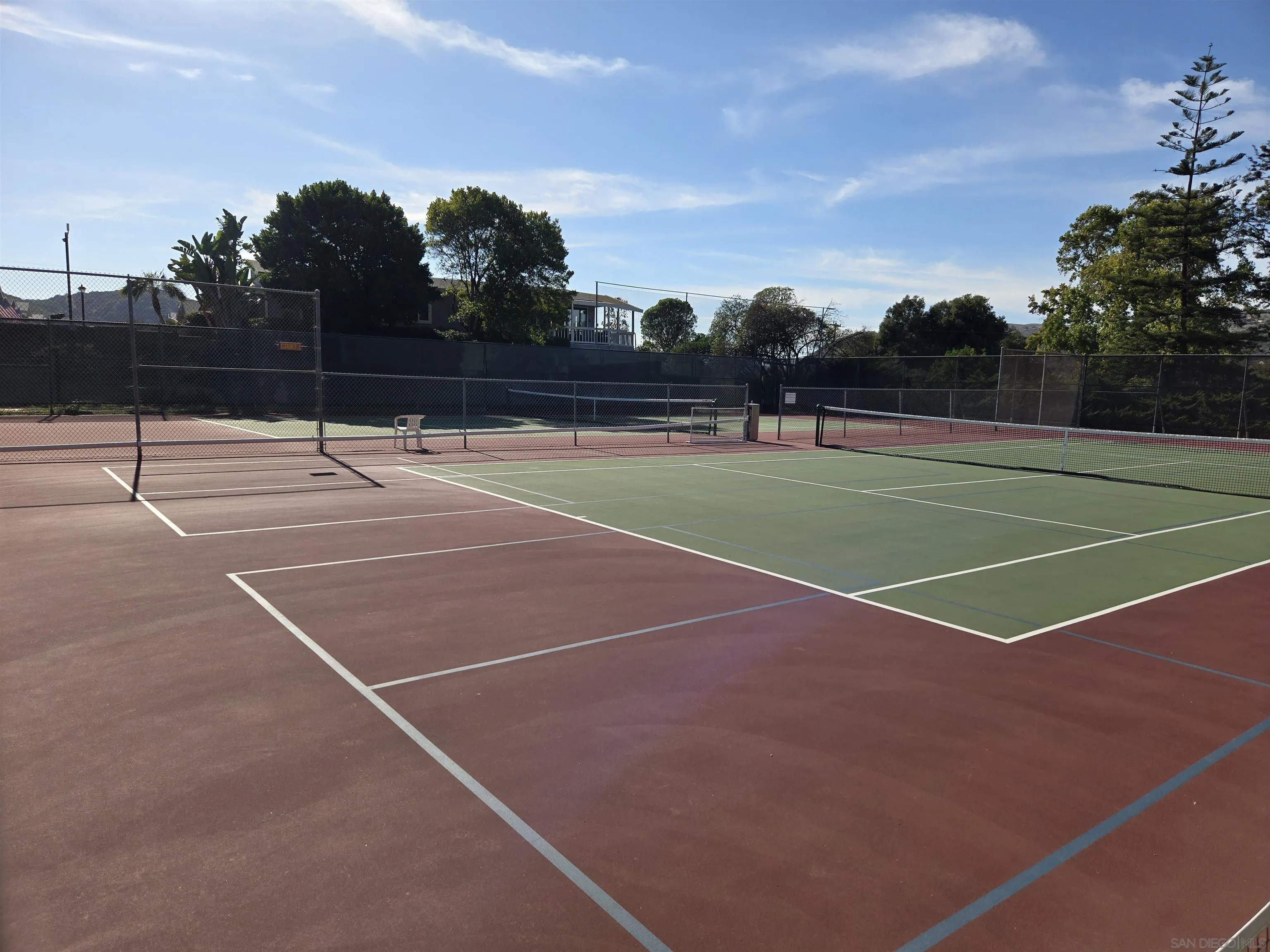 4650 Dulin Road, Unit 162 Fallbrook, CA 92003 - Photo 36 of 36 a view of tennis court with trees in the background