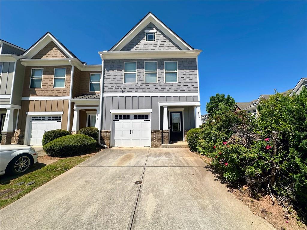 2655 Avanti Way Decatur, GA 30035 - Photo 1 of 12 a front view of a house with a yard and garage