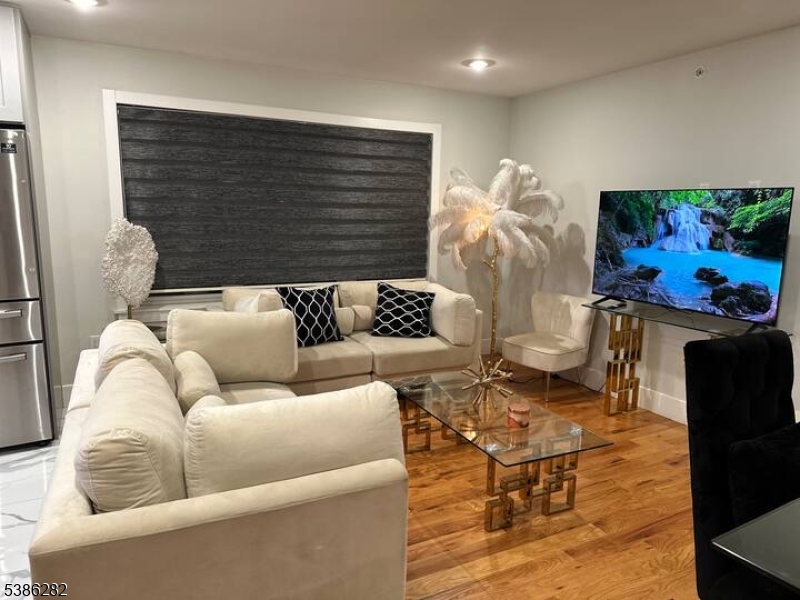 859 Main Street, Unit 40 Paterson, NJ 07503 - Photo 2 of 10 a living room with fireplace furniture and a wooden floor