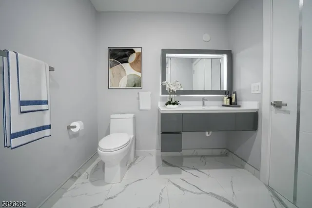 a bathroom with a toilet sink and mirror