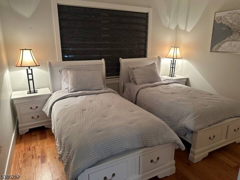 859 Main Street, Unit 40 Paterson, NJ 07503 - Photo 7 of 10 a bed room with two bed and a night stand