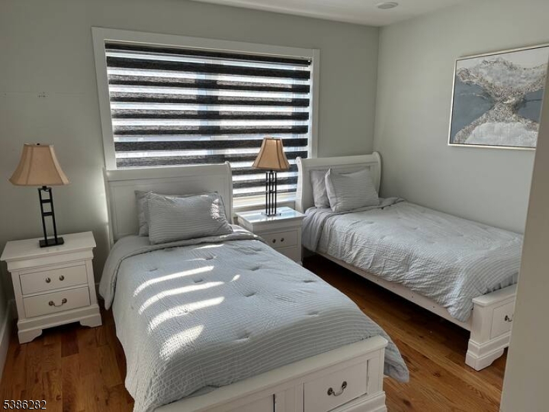 859 Main Street, Unit 40 Paterson, NJ 07503 - Photo 9 of 10 a bedroom with a bed and a night stand