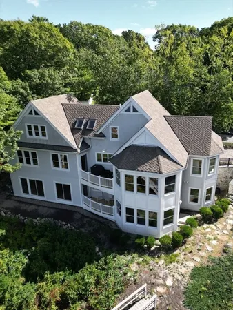 a aerial view of a house next to a yard