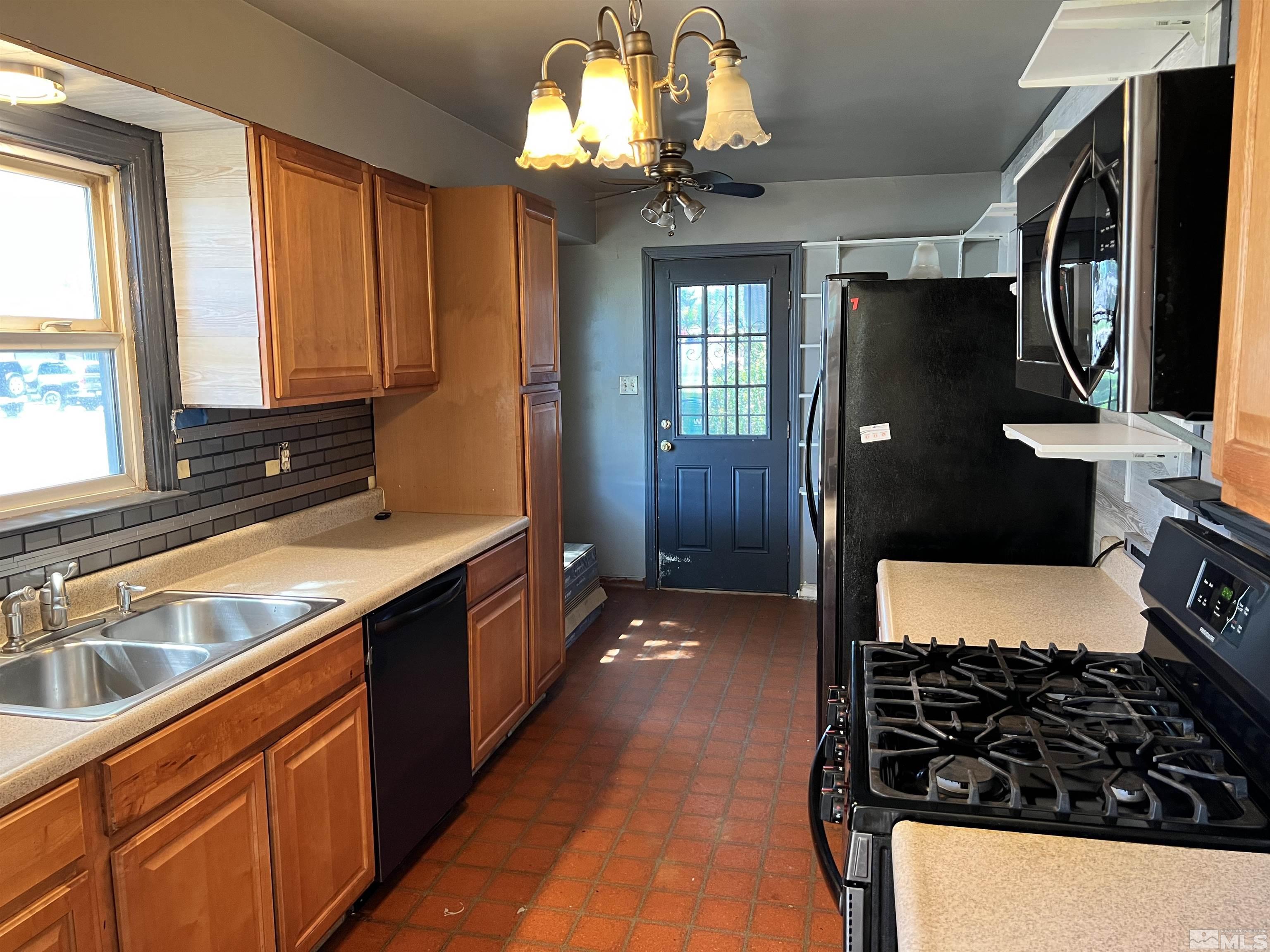 912 Bates Avenue Reno, NV 89502 - Photo 4 of 7 a kitchen with stainless steel appliances a sink stove and cabinets