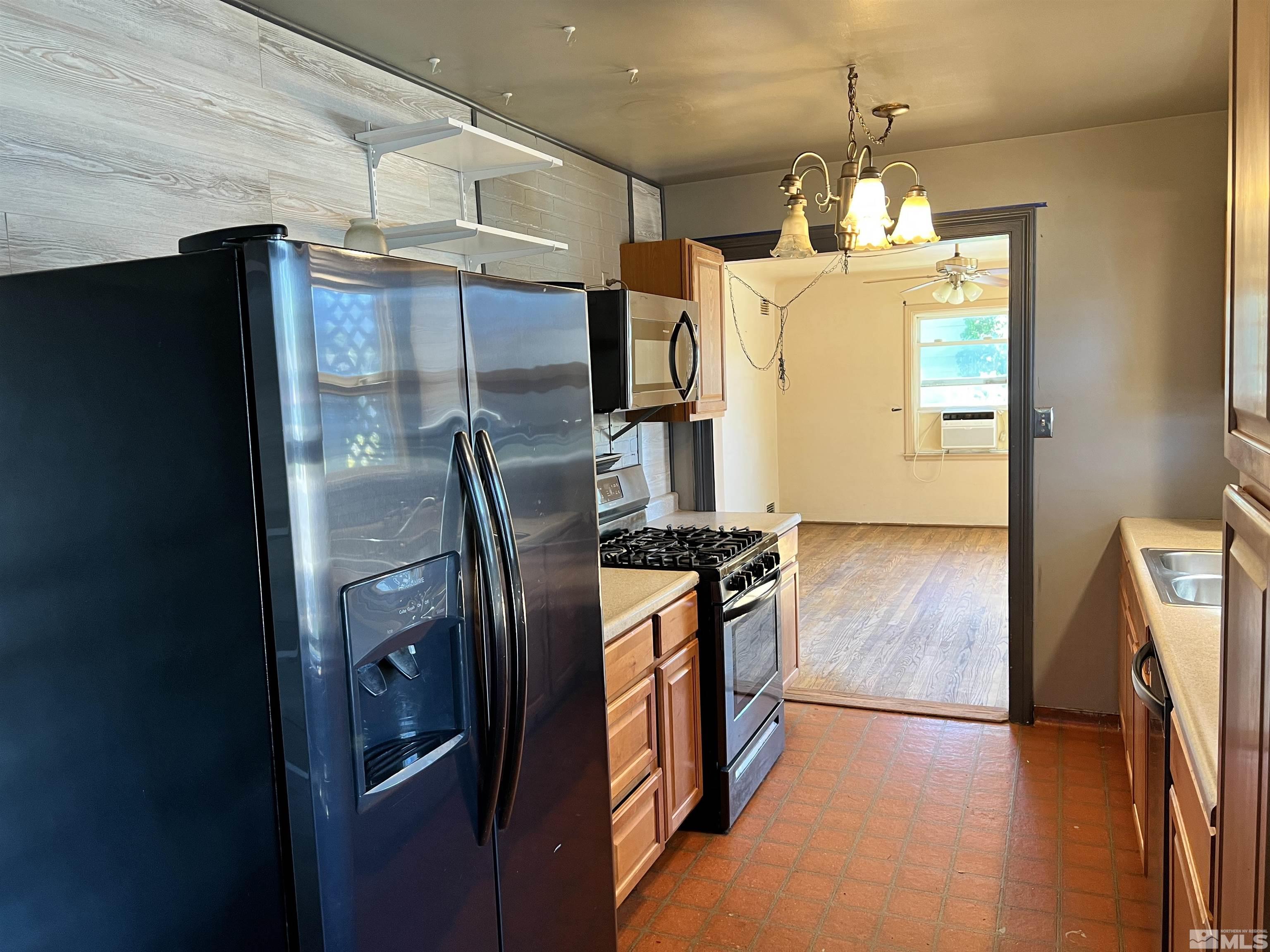 912 Bates Avenue Reno, NV 89502 - Photo 5 of 7 a kitchen with stainless steel appliances granite countertop a refrigerator a stove and a sink