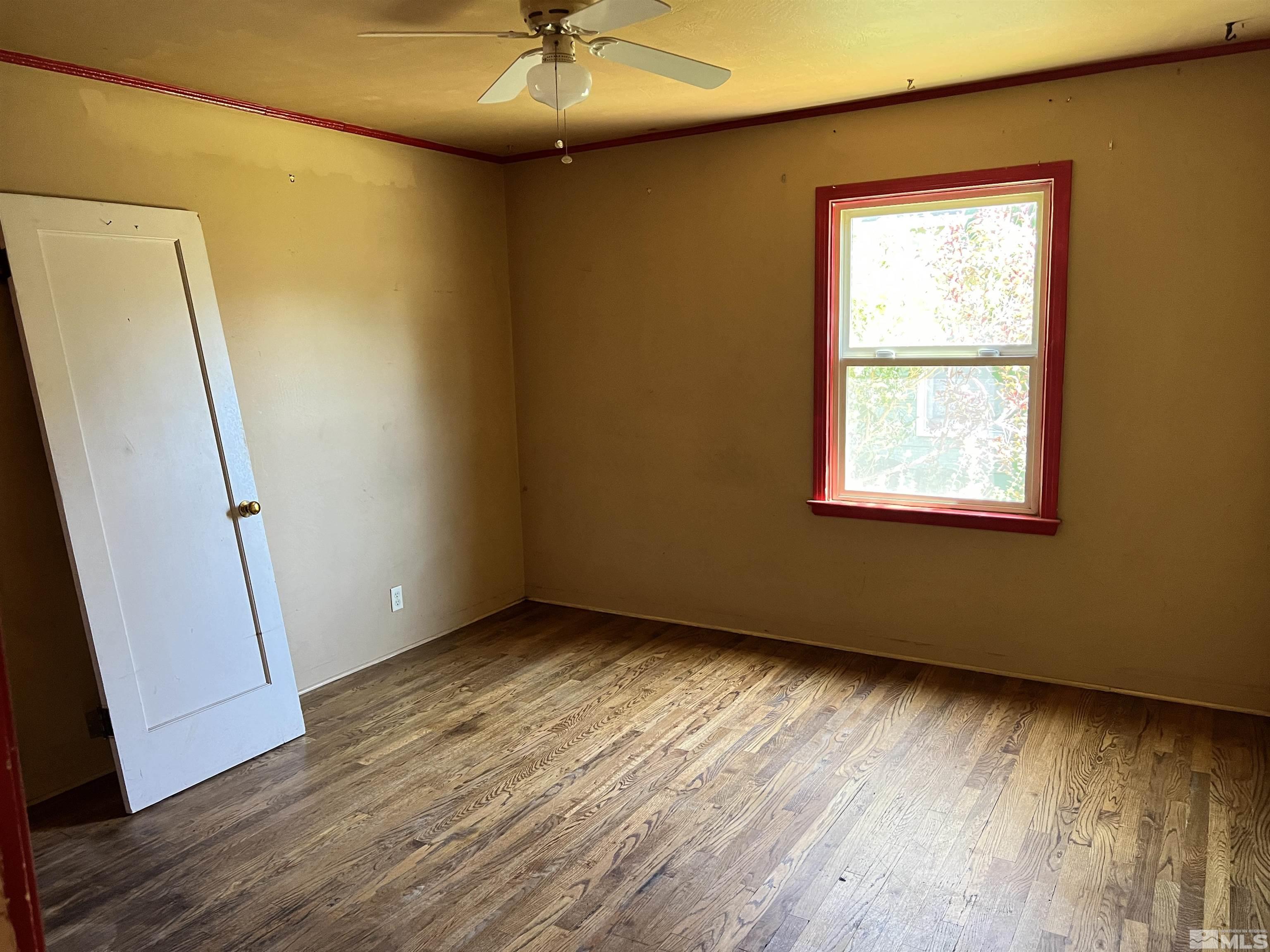912 Bates Avenue Reno, NV 89502 - Photo 6 of 7 an empty room with wooden floor and windows