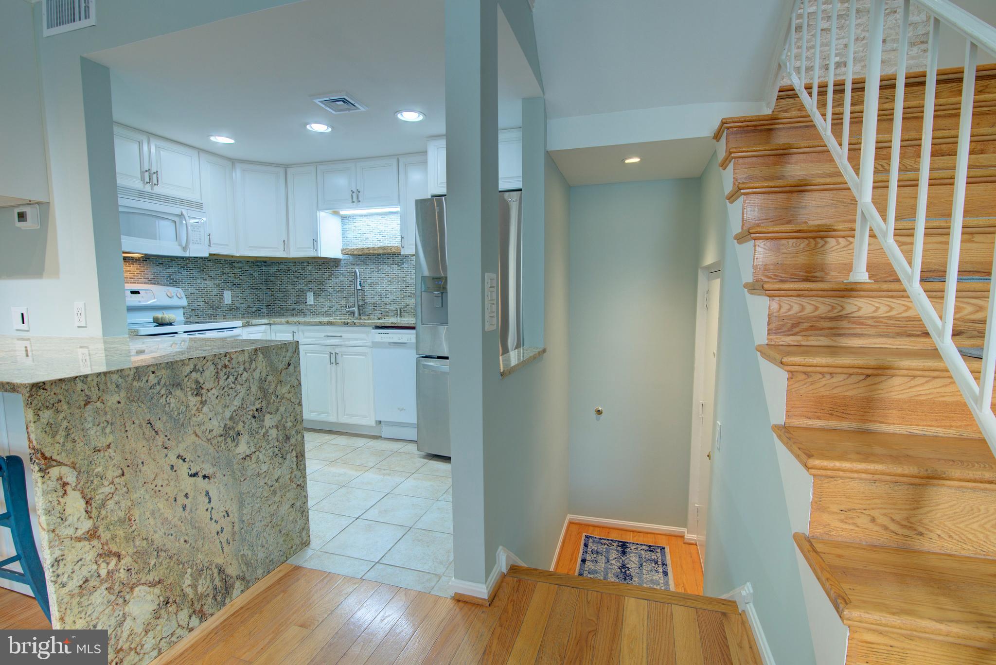 1953 Calvert Street Northwest, Unit D Washington, DC 20009 - Photo 12 of 27 a kitchen with stainless steel appliances granite countertop a sink and a refrigerator