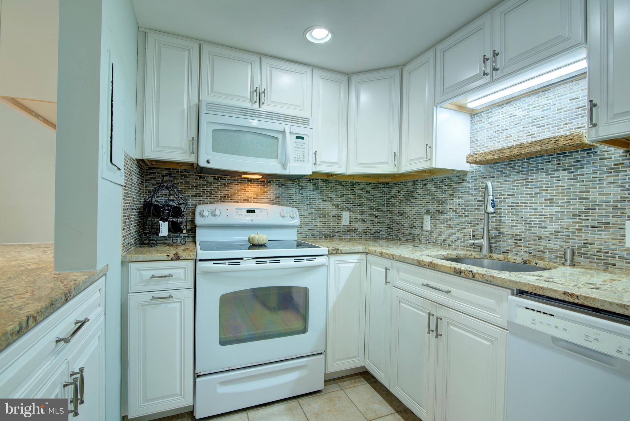 1953 Calvert Street Northwest, Unit D Washington, DC 20009 - Photo 15 of 27 a kitchen with a sink stove and cabinets