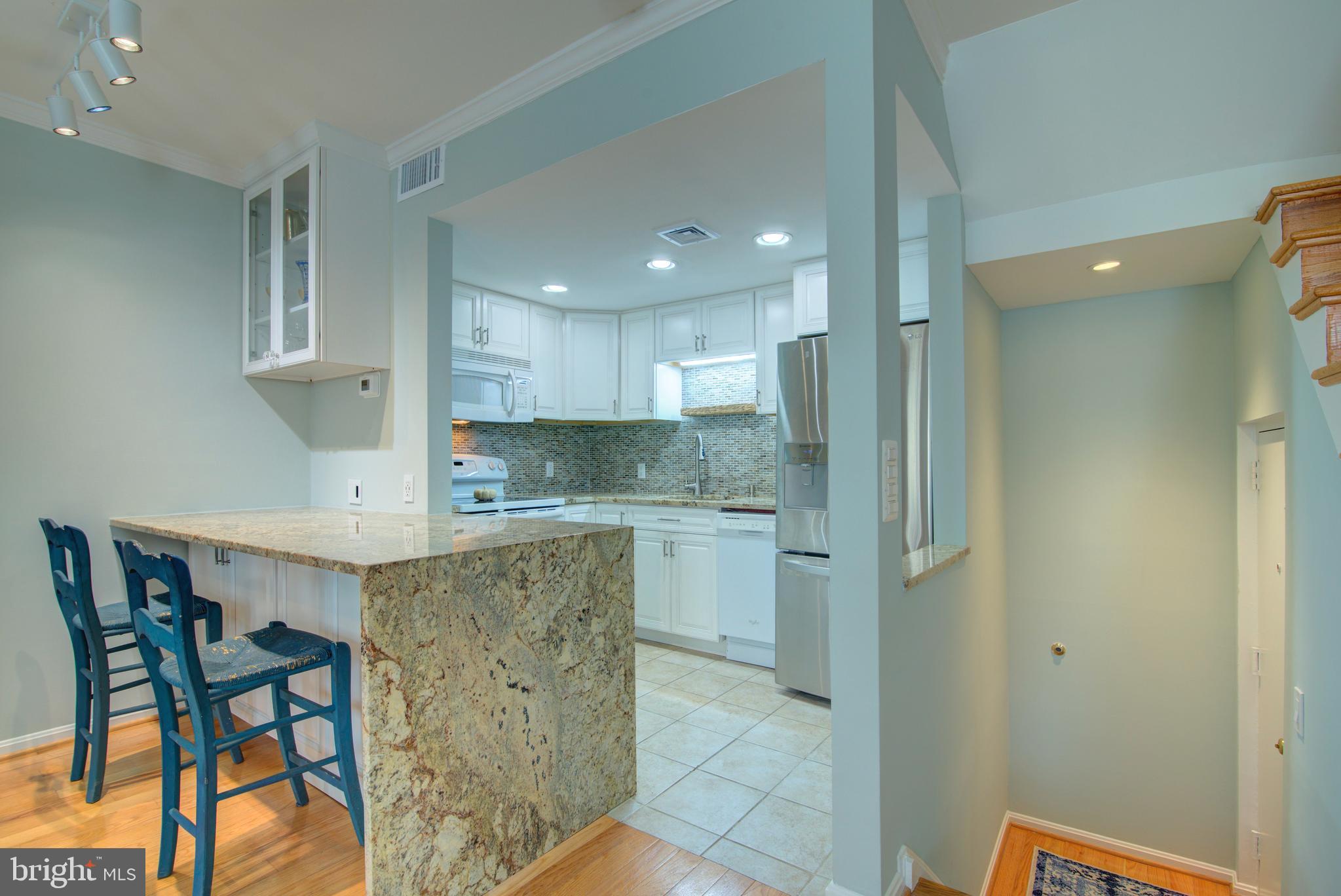 1953 Calvert Street Northwest, Unit D Washington, DC 20009 - Photo 7 of 27 a kitchen with a table and chairs in it