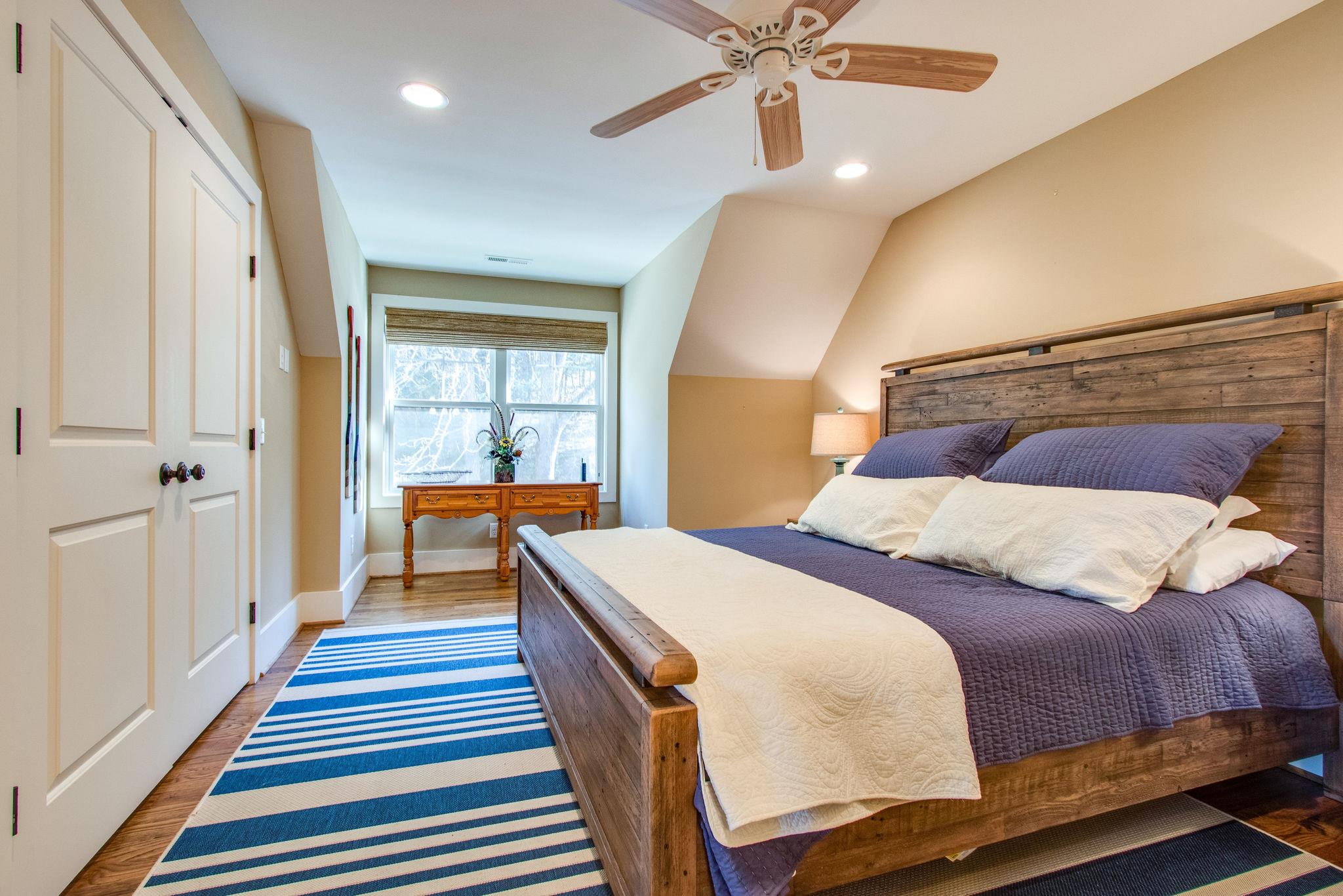 750 Floating Mill Village Road Silver Point, TN 38582 - Photo 18 of 30 a bedroom with a bed and wooden floor