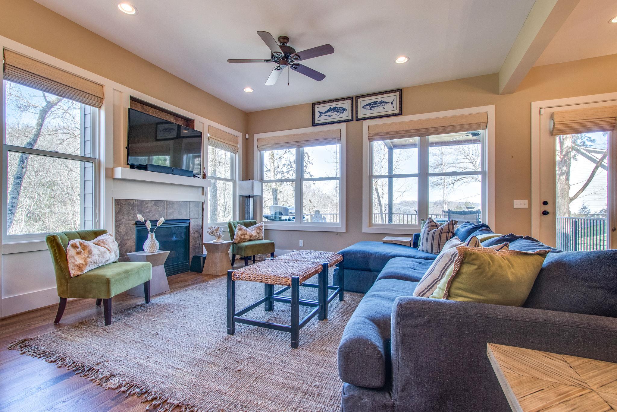 750 Floating Mill Village Road Silver Point, TN 38582 - Photo 6 of 30 a living room with furniture a flat screen tv and a fireplace
