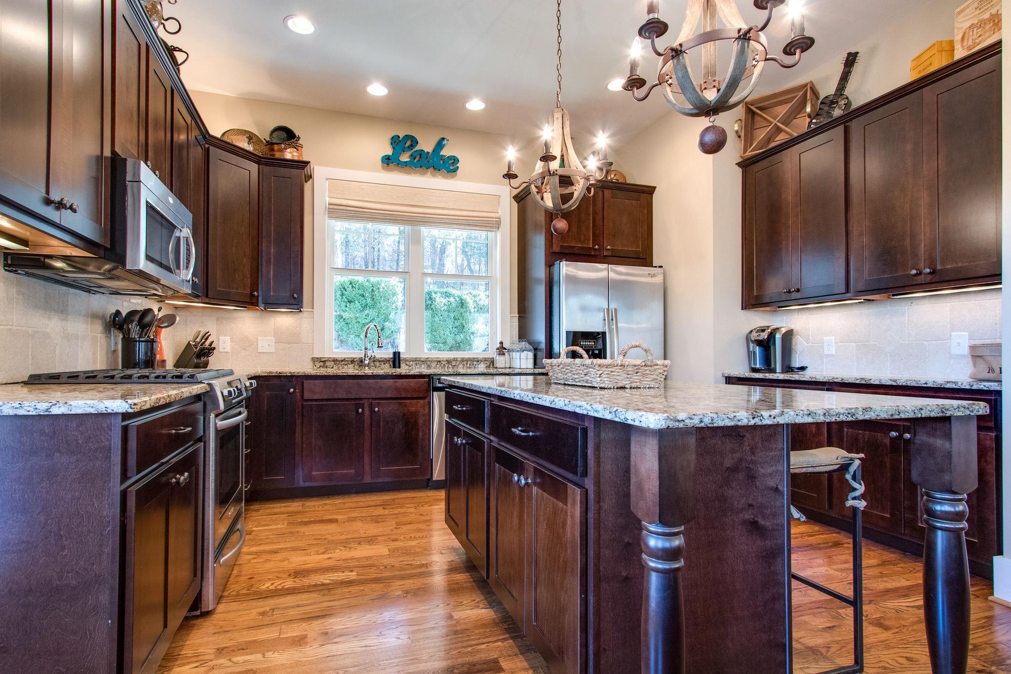 750 Floating Mill Village Road Silver Point, TN 38582 - Photo 8 of 30 a kitchen with stainless steel appliances granite countertop a stove a sink dishwasher and a refrigerator with wooden floor